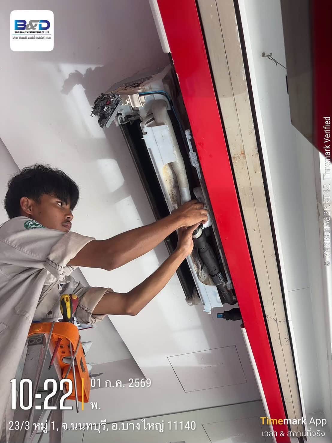 Technician spraying and rinsing an air conditioner coil